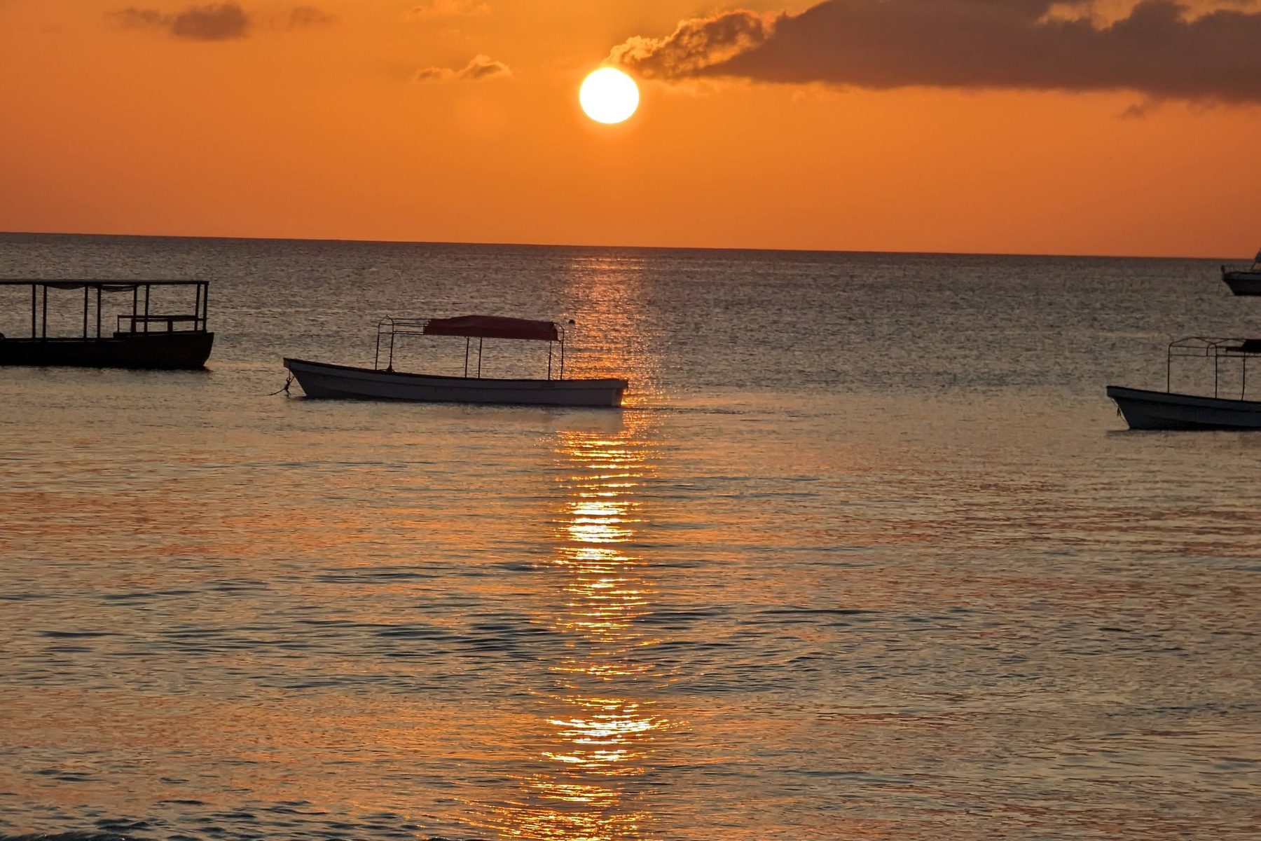 Boats on calm water at sunset off the Kenyan coast